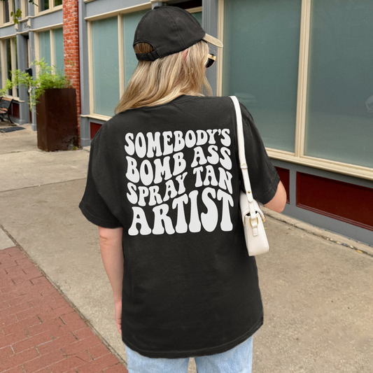 Somebody's Bomb Ass Spray Tan Artist Graphic Tee